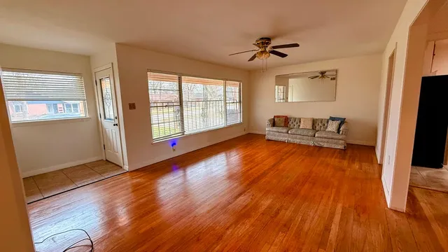wooden floor in an empty room with a window