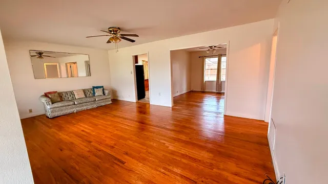 a view of livingroom with hardwood floor and a ceiling fan