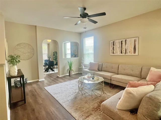 a living room with furniture and wooden floor