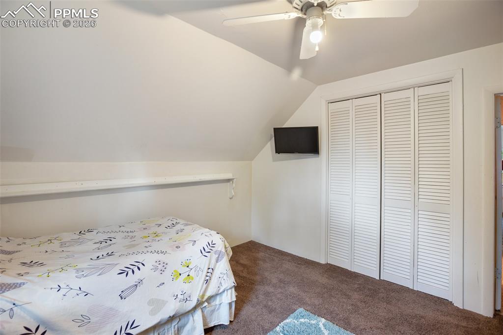 377 Ridge Road Divide, CO 80814 - Photo 38 of 50 a bedroom with a bed and a chandelier