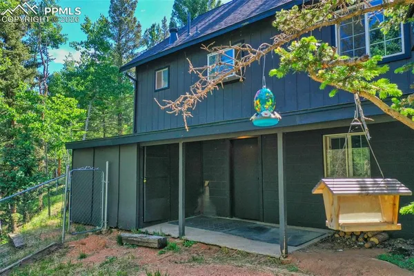 a view of a wooden deck with a small yard