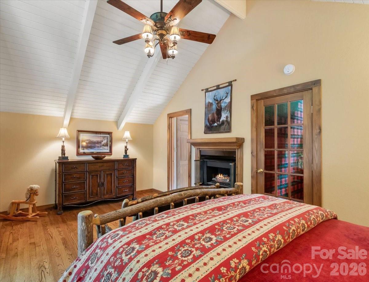 121 Ivy Ridge Road Burnsville, NC 28714 - Photo 32 of 48 a bedroom with a bed and a fireplace