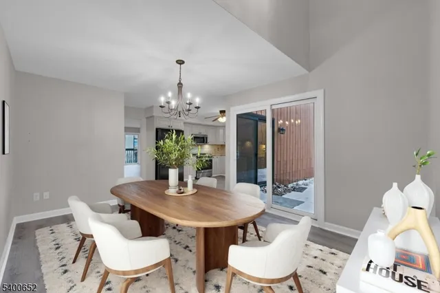a view of a dining room with furniture and chandelier