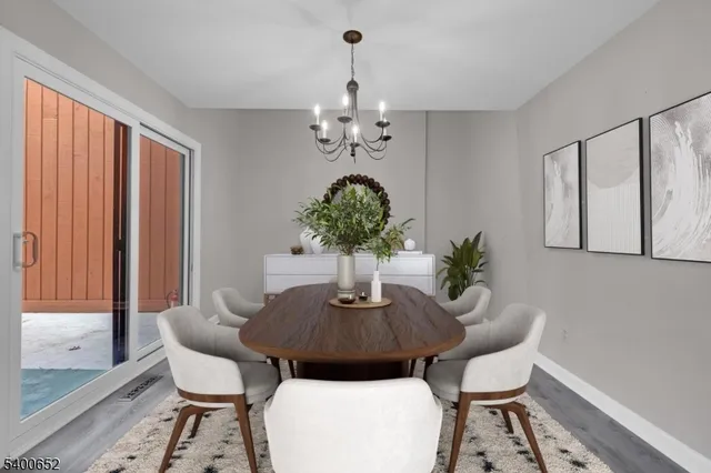 a dining room with furniture and chandelier
