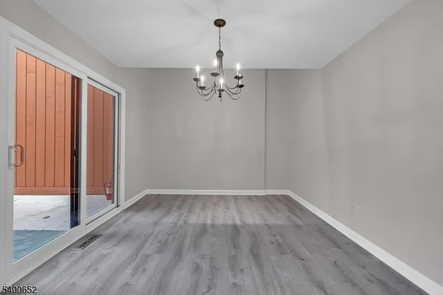 wooden floor in a hall with an empty room