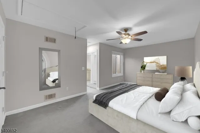 a bedroom with a large bed and a chandelier