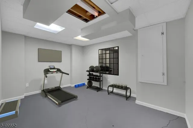 a living room with furniture a air conditioner and a window