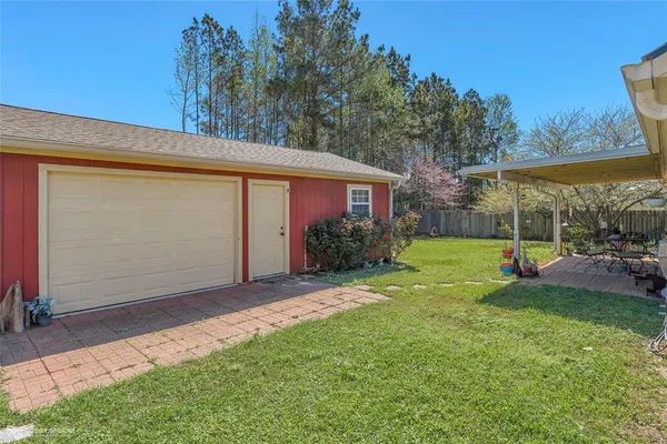 a view of a house with backyard and porch