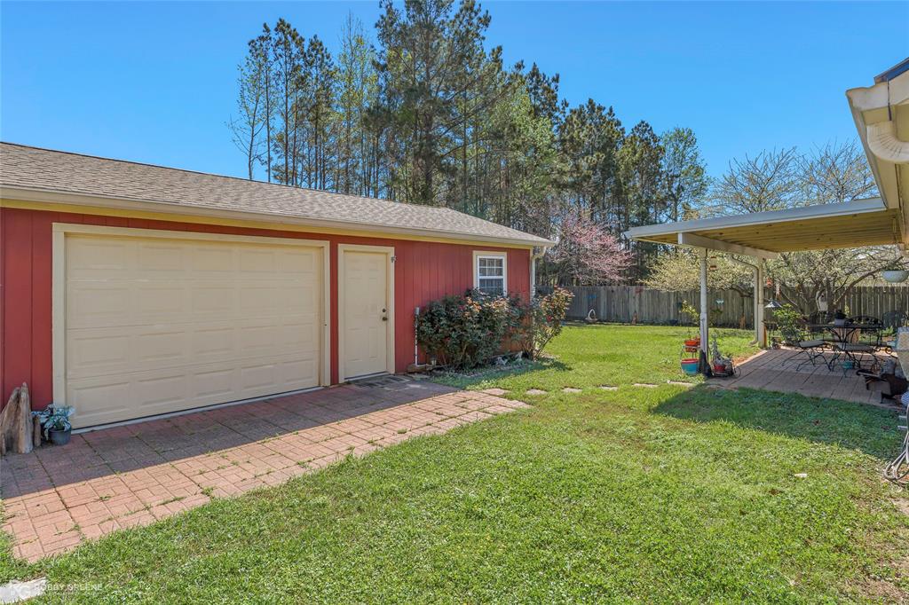 7193 Laurel Ridge Drive Greenwood, LA 71033 - Photo 14 of 40 Fenced yard featuring a garage and an outdoor structure