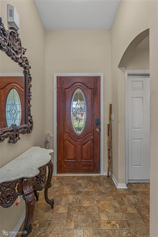 7193 Laurel Ridge Drive Greenwood, LA 71033 - Photo 21 of 40 Foyer entrance featuring stone finish floors and arched walkways