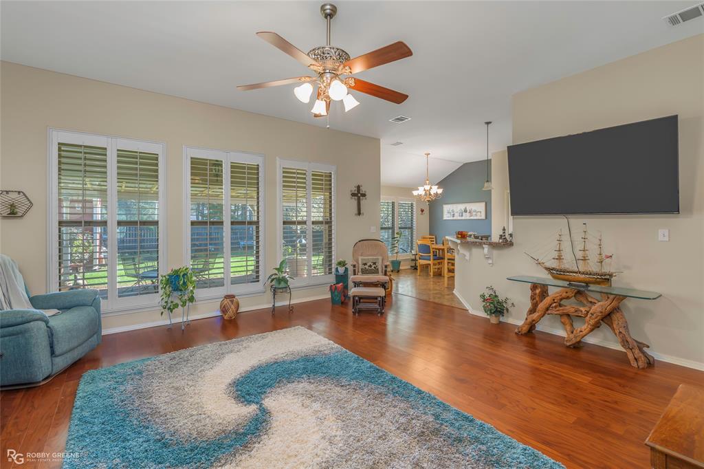 7193 Laurel Ridge Drive Greenwood, LA 71033 - Photo 22 of 40 Sitting room with suspended lighting, ceiling fan, dark wood-type flooring, and vaulted ceiling