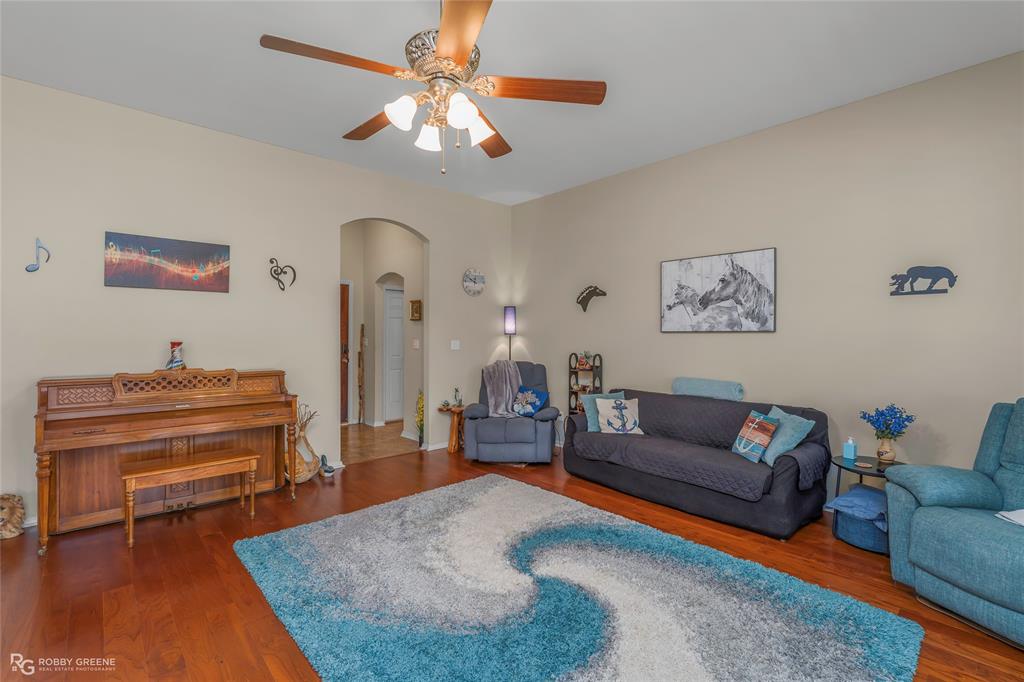 7193 Laurel Ridge Drive Greenwood, LA 71033 - Photo 24 of 40 Living area featuring arched walkways, wood finished floors, and a ceiling fan