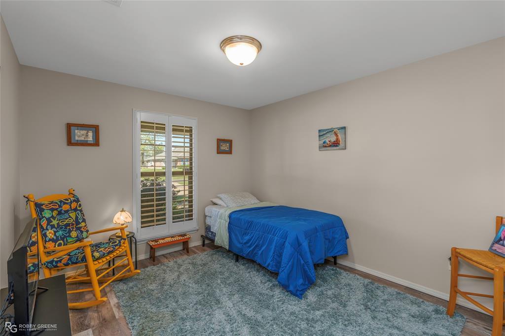7193 Laurel Ridge Drive Greenwood, LA 71033 - Photo 31 of 40 Bedroom with wood finished floors and baseboards