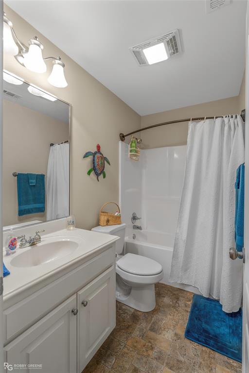 7193 Laurel Ridge Drive Greenwood, LA 71033 - Photo 35 of 40 Full bathroom featuring stone finish floors, vanity, and shower / bathtub combination with curtain