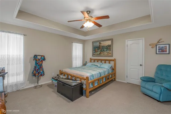 a bedroom with bed and ceiling fan