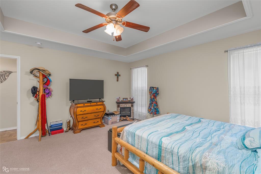 7193 Laurel Ridge Drive Greenwood, LA 71033 - Photo 37 of 40 Carpeted bedroom featuring a raised ceiling and ceiling fan