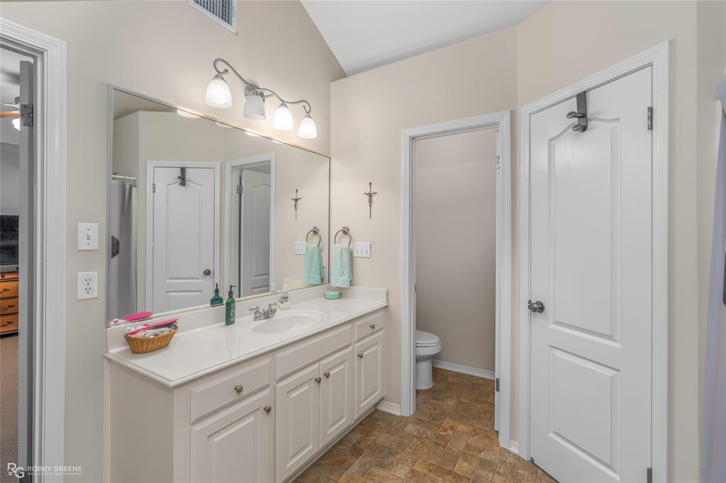 7193 Laurel Ridge Drive Greenwood, LA 71033 - Photo 38 of 40 Bathroom with stone finish flooring, vanity, and a ceiling fan