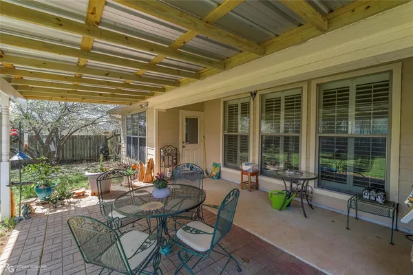 a building outdoor space with patio furniture and potted plants