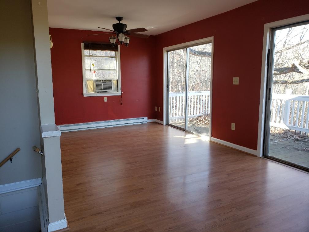 2121 Byrd Road Elliston, VA 24087 - Photo 7 of 20 a view of an empty room with wooden floor and a window