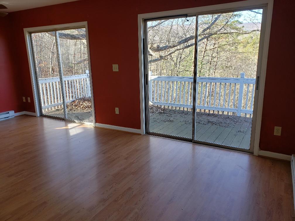 2121 Byrd Road Elliston, VA 24087 - Photo 8 of 20 an empty room with wooden floor and balcony