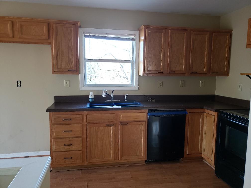 2121 Byrd Road Elliston, VA 24087 - Photo 10 of 20 a kitchen with granite countertop wooden cabinets a sink and a window