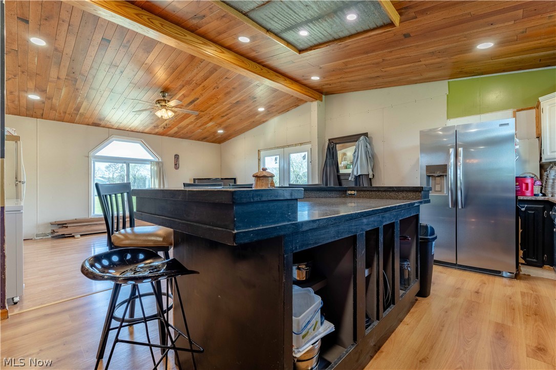 5267 Apollo Road Northeast Salineville, OH 43945 - Photo 10 of 33 Kitchen with a kitchen breakfast bar, stainless steel fridge with ice dispenser, healthy amount of natural light, light wood-type flooring, and recessed lighting
