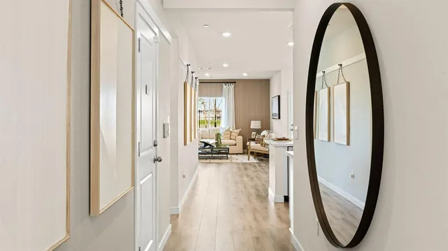 a kitchen with stainless steel appliances a dining table chairs stove refrigerator and cabinets