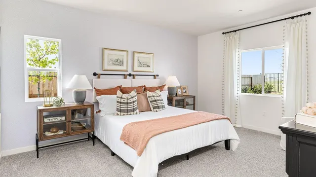 a view of a hallway with wooden floor and a bathroom