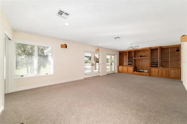 a front view of a house with stairs and wooden fence