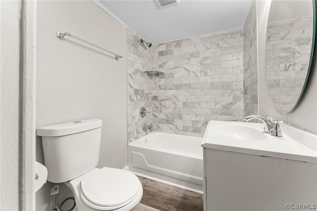 452 Harding Street Petersburg, VA 23803 - Photo 12 of 39 a white toilet sitting next to a bath tub
