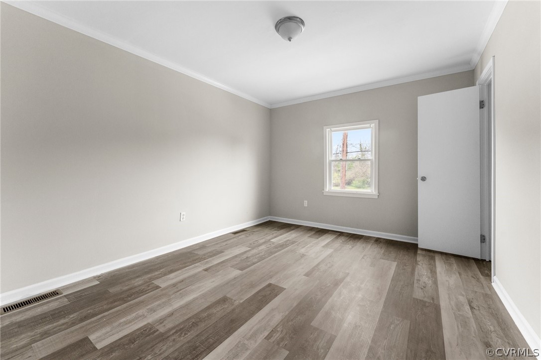 452 Harding Street Petersburg, VA 23803 - Photo 16 of 39 an empty room with wooden floor and windows