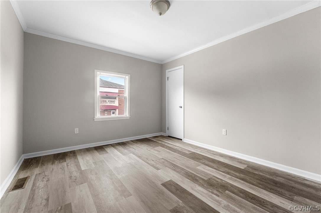 452 Harding Street Petersburg, VA 23803 - Photo 17 of 39 an empty room with wooden floor and windows