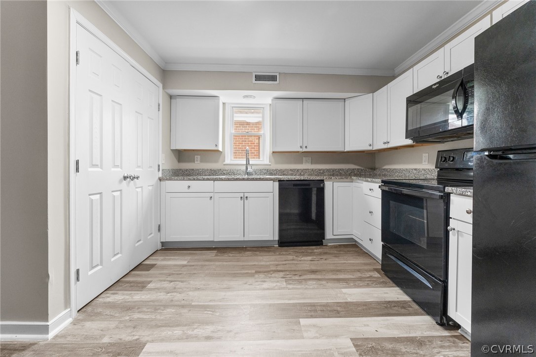 452 Harding Street Petersburg, VA 23803 - Photo 27 of 39 a kitchen with stainless steel appliances granite countertop a stove top oven a sink dishwasher and a refrigerator with wooden floor