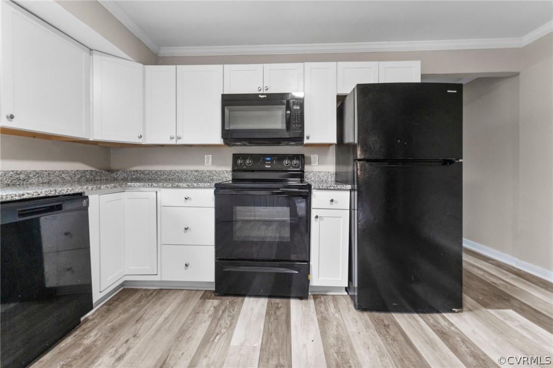 452 Harding Street Petersburg, VA 23803 - Photo 28 of 39 a kitchen with a refrigerator stove and white cabinets