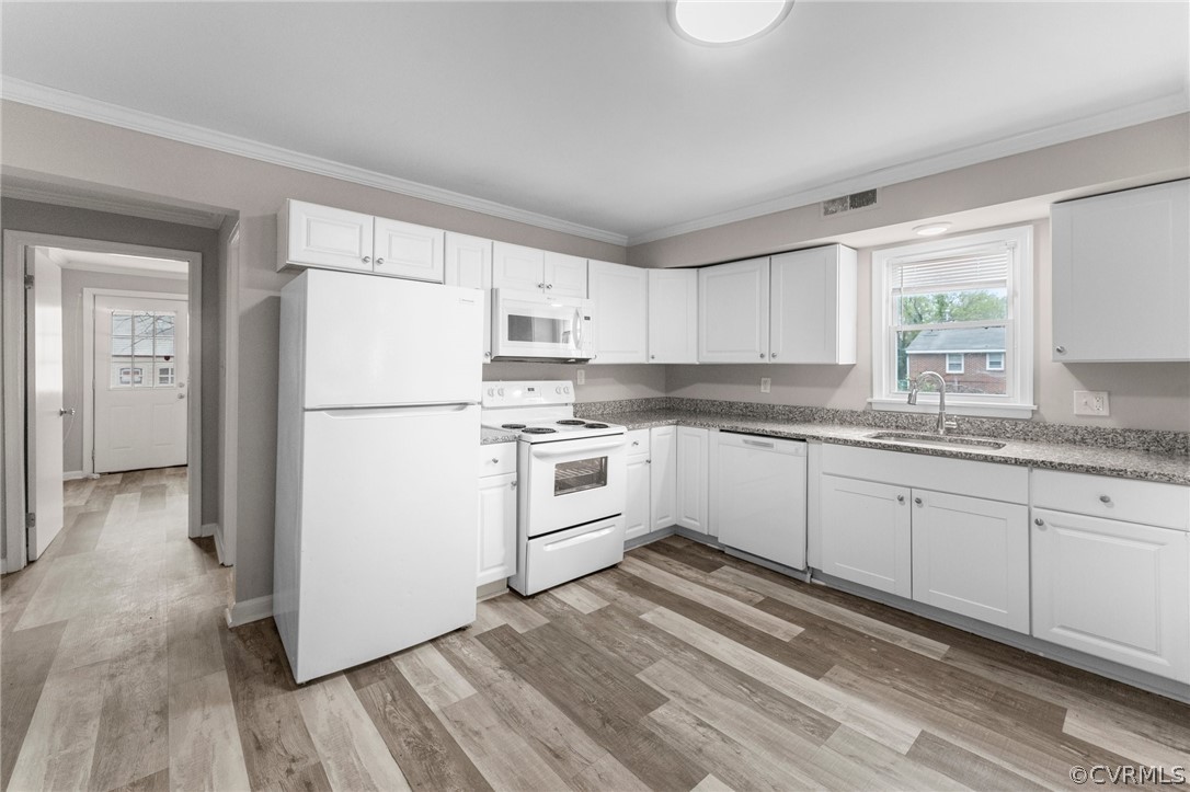 452 Harding Street Petersburg, VA 23803 - Photo 9 of 39 a kitchen with white cabinets and white appliances