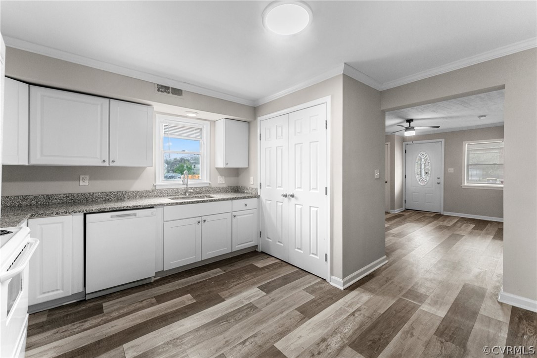 452 Harding Street Petersburg, VA 23803 - Photo 10 of 39 a kitchen with granite countertop a refrigerator and white cabinets
