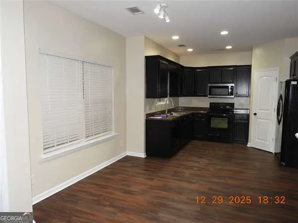 a kitchen with stainless steel appliances granite countertop a stove and a refrigerator