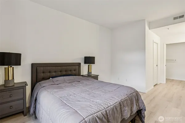 a bedroom with a bed and a night stand