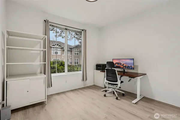 a view of a workspace with furniture and a window