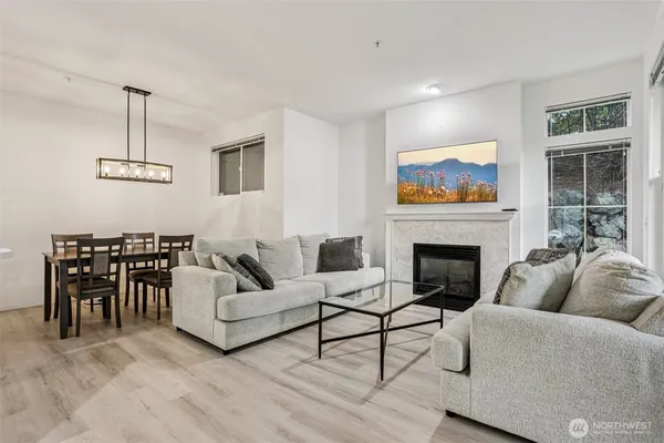 a living room with furniture a fireplace and a flat screen tv