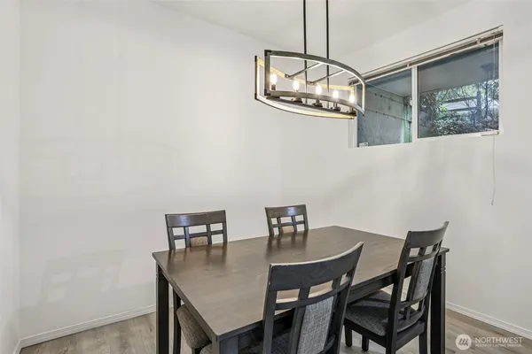 a view of a dining room with a table and chairs