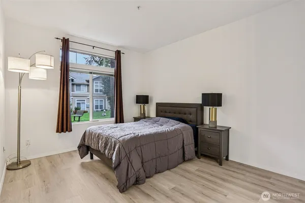 a bedroom with a bed and wooden floor