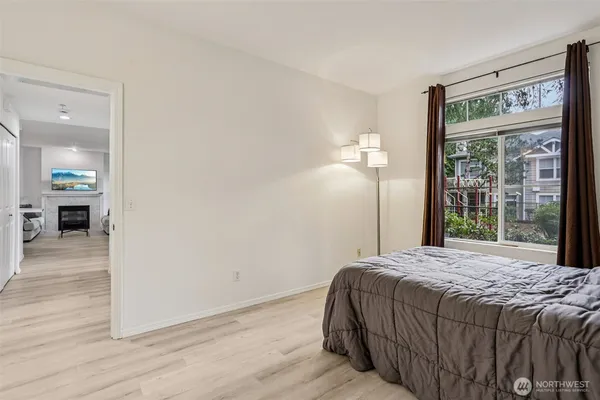 a bedroom with a bed and wooden floor