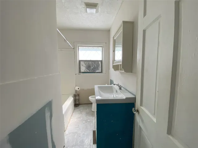 a en suite bathroom with a sink toilet and a mirror