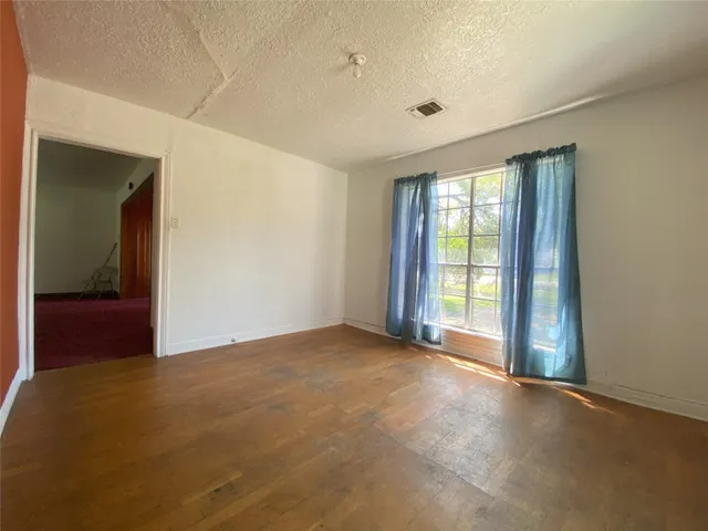 a view of an empty room with glass door
