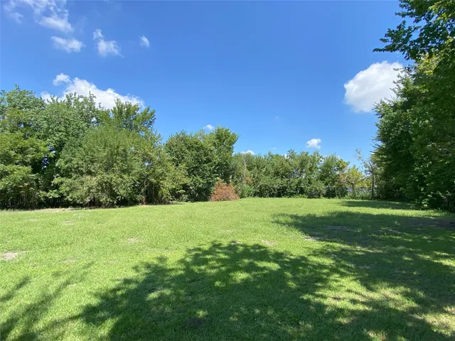 a view of field with trees in the background