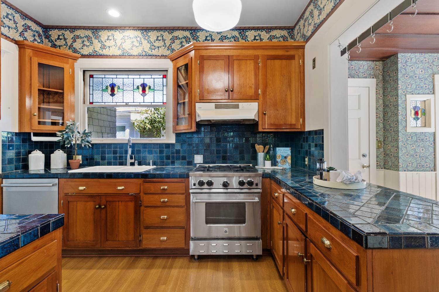 1705 H Street Sacramento, CA 95811 - Photo 20 of 50 a kitchen with stainless steel appliances granite countertop a stove a sink and a microwave
