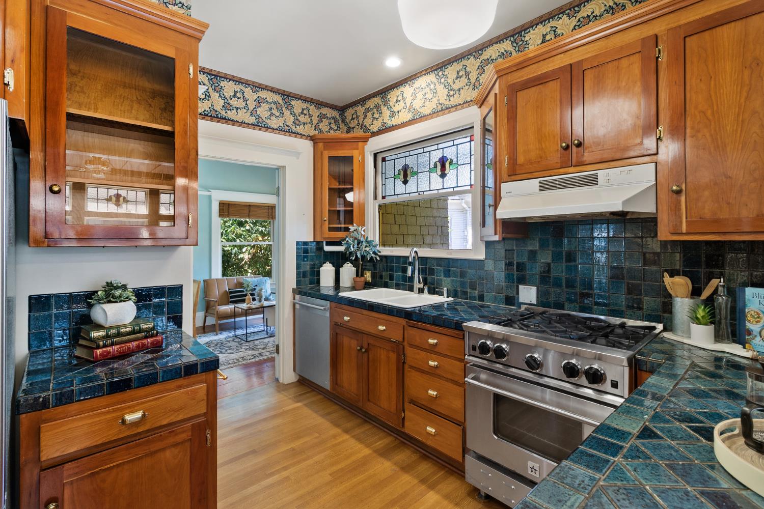 1705 H Street Sacramento, CA 95811 - Photo 21 of 50 a kitchen with stainless steel appliances granite countertop a stove a sink and a microwave