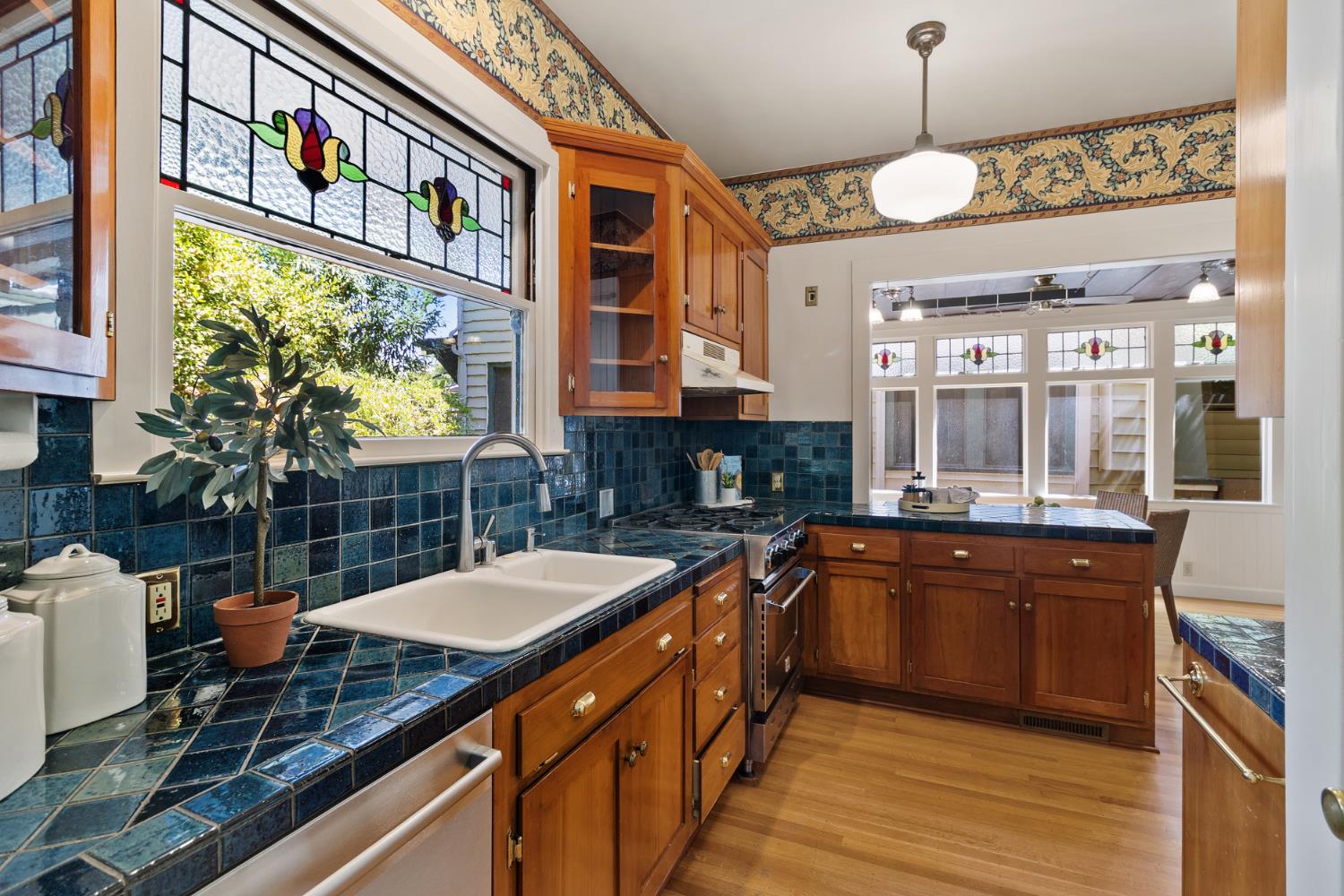 1705 H Street Sacramento, CA 95811 - Photo 22 of 50 a kitchen with stainless steel appliances kitchen island granite countertop a sink and cabinets