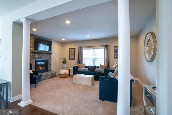 a living room with furniture a fireplace and a flat screen tv